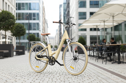 Vélo ADO Canada AIR28 yellow E-bike with sleek frame and modern design, parked outdoors on a sunny day.